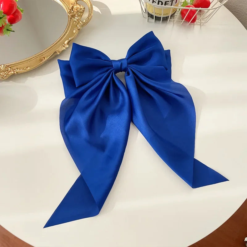 Elegant satin bow hair clip with strong hold and soft feminine style.