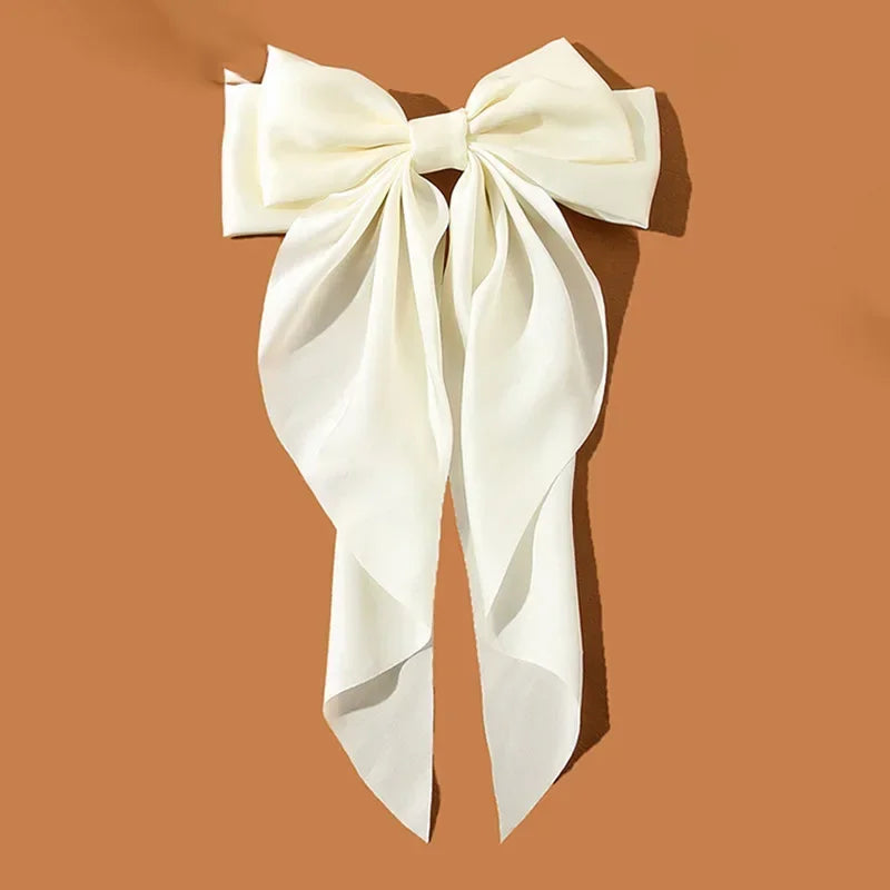 Elegant satin bow hair clip with strong hold and soft feminine style.