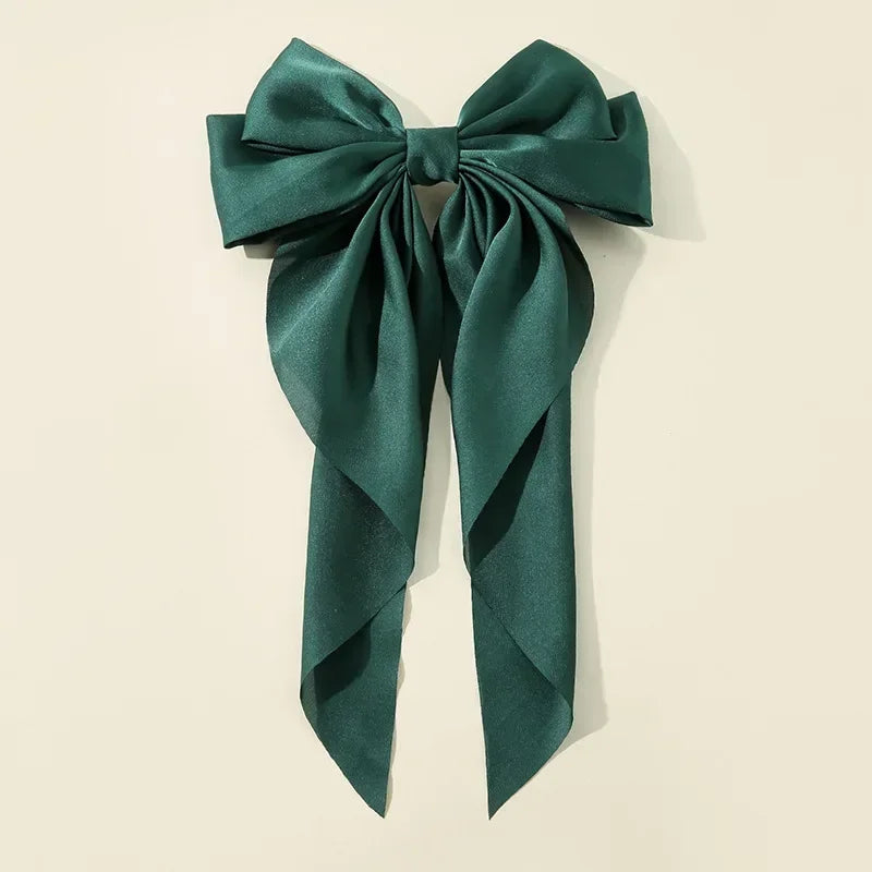 Elegant satin bow hair clip with strong hold and soft feminine style.