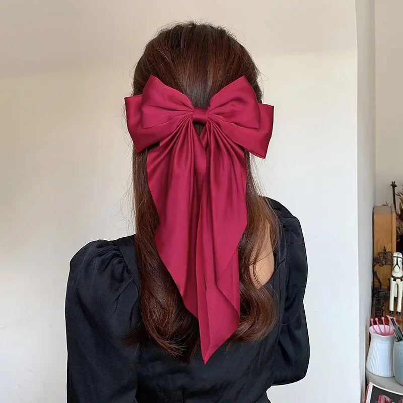 Elegant satin bow hair clip with strong hold and soft feminine style.