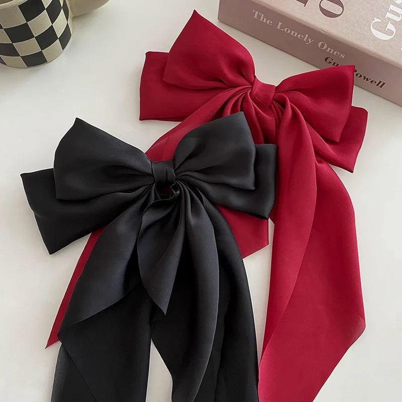 Elegant satin bow hair clip with strong hold and soft feminine style.