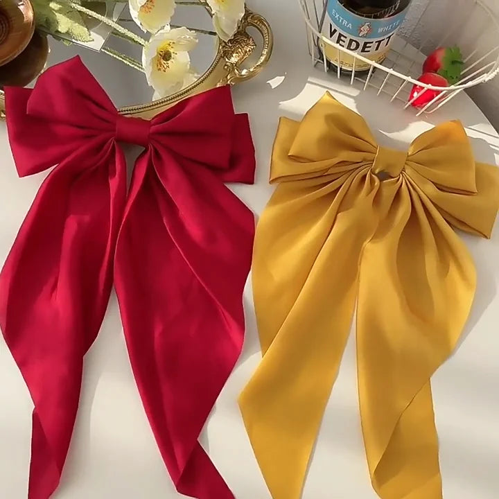 Elegant satin bow hair clip with strong hold and soft feminine style.