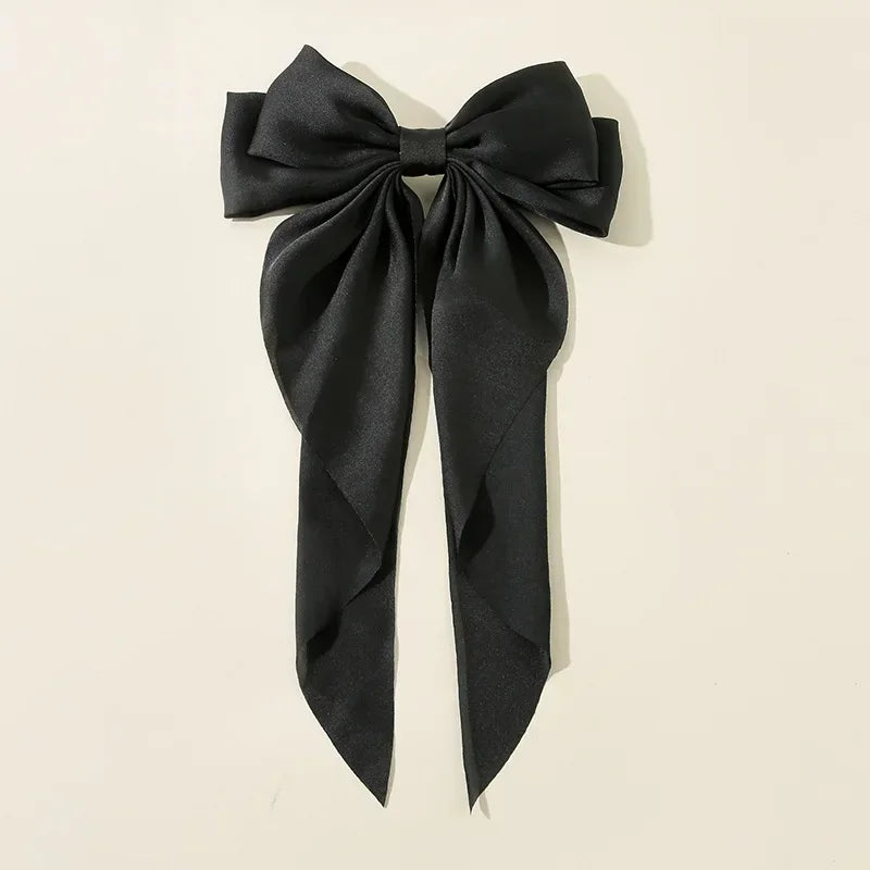 Elegant satin bow hair clip with strong hold and soft feminine style.