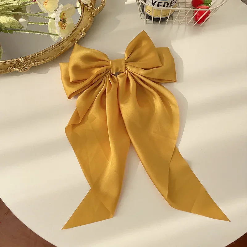 Elegant satin bow hair clip with strong hold and soft feminine style.
