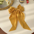 Elegant satin bow hair clip with strong hold and soft feminine style.