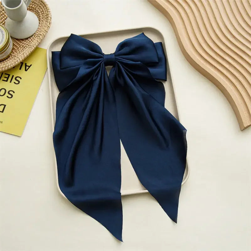 Elegant satin bow hair clip with strong hold and soft feminine style.