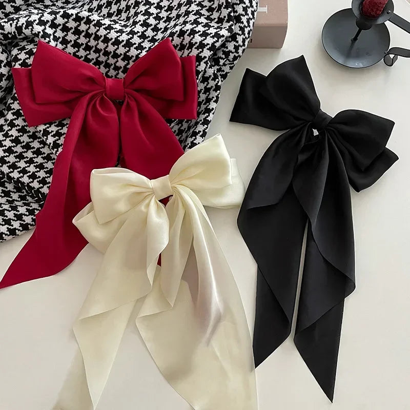 Elegant satin bow hair clip with strong hold and soft feminine style.