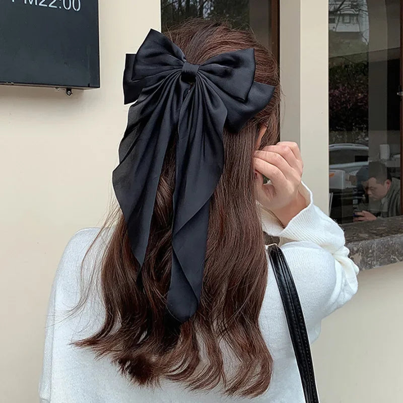 Elegant satin bow hair clip with strong hold and soft feminine style.