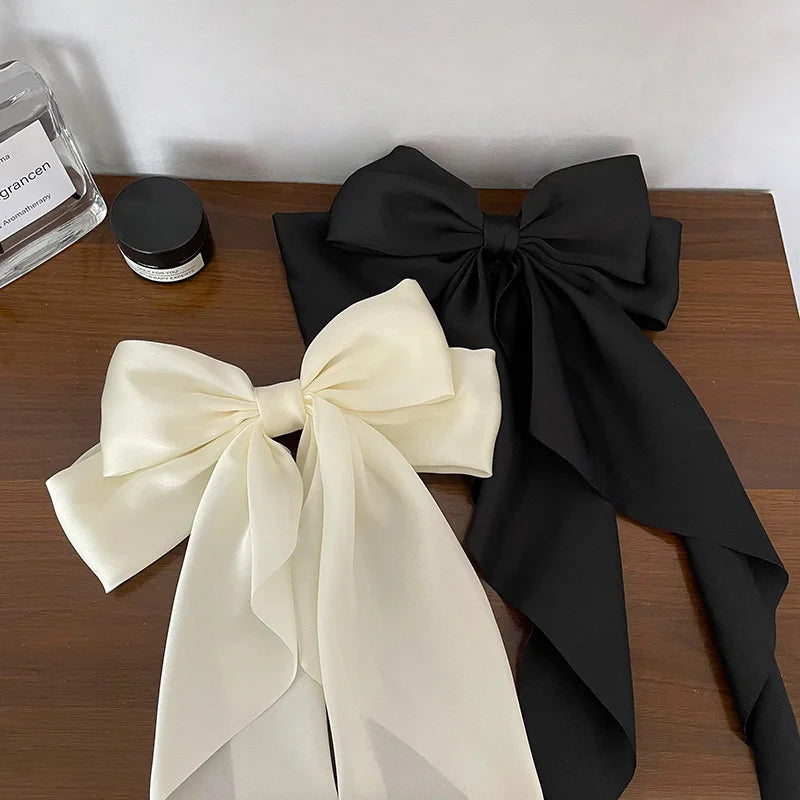 Elegant satin bow hair clip with strong hold and soft feminine style.