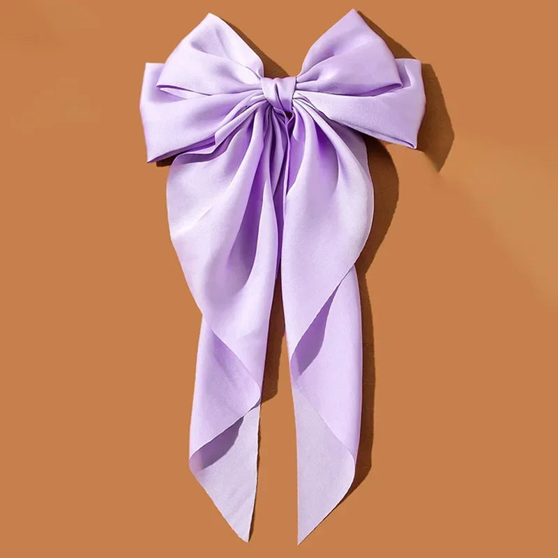 Elegant satin bow hair clip with strong hold and soft feminine style.