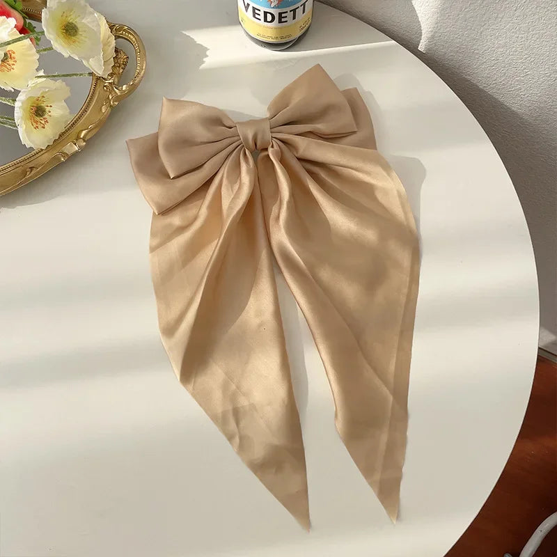 Elegant satin bow hair clip with strong hold and soft feminine style.