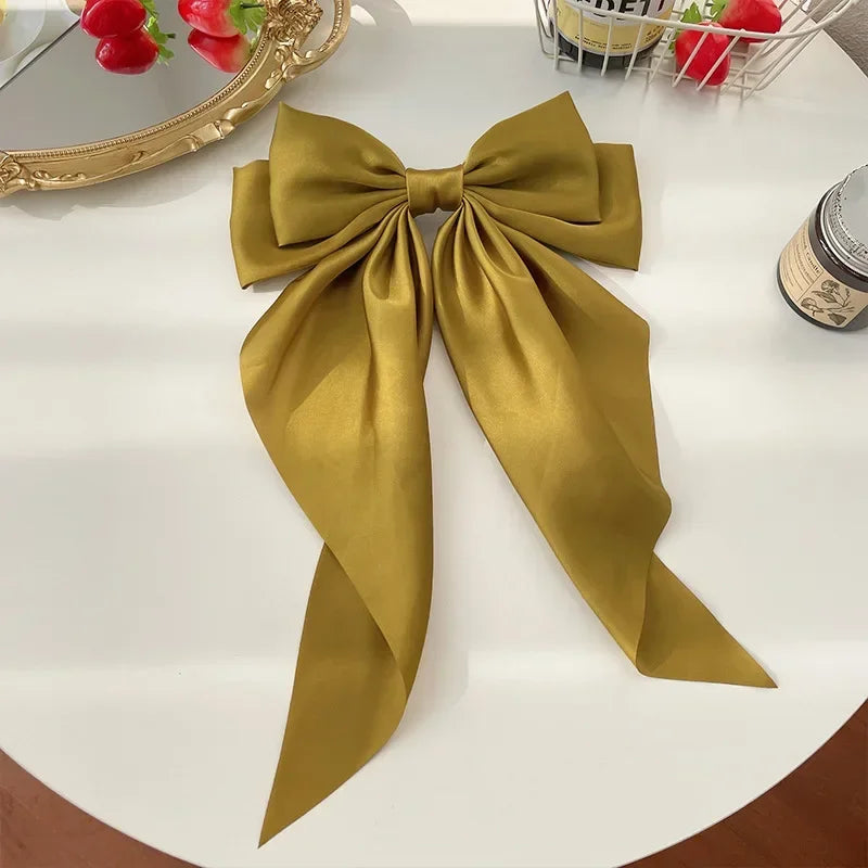 Elegant satin bow hair clip with strong hold and soft feminine style.