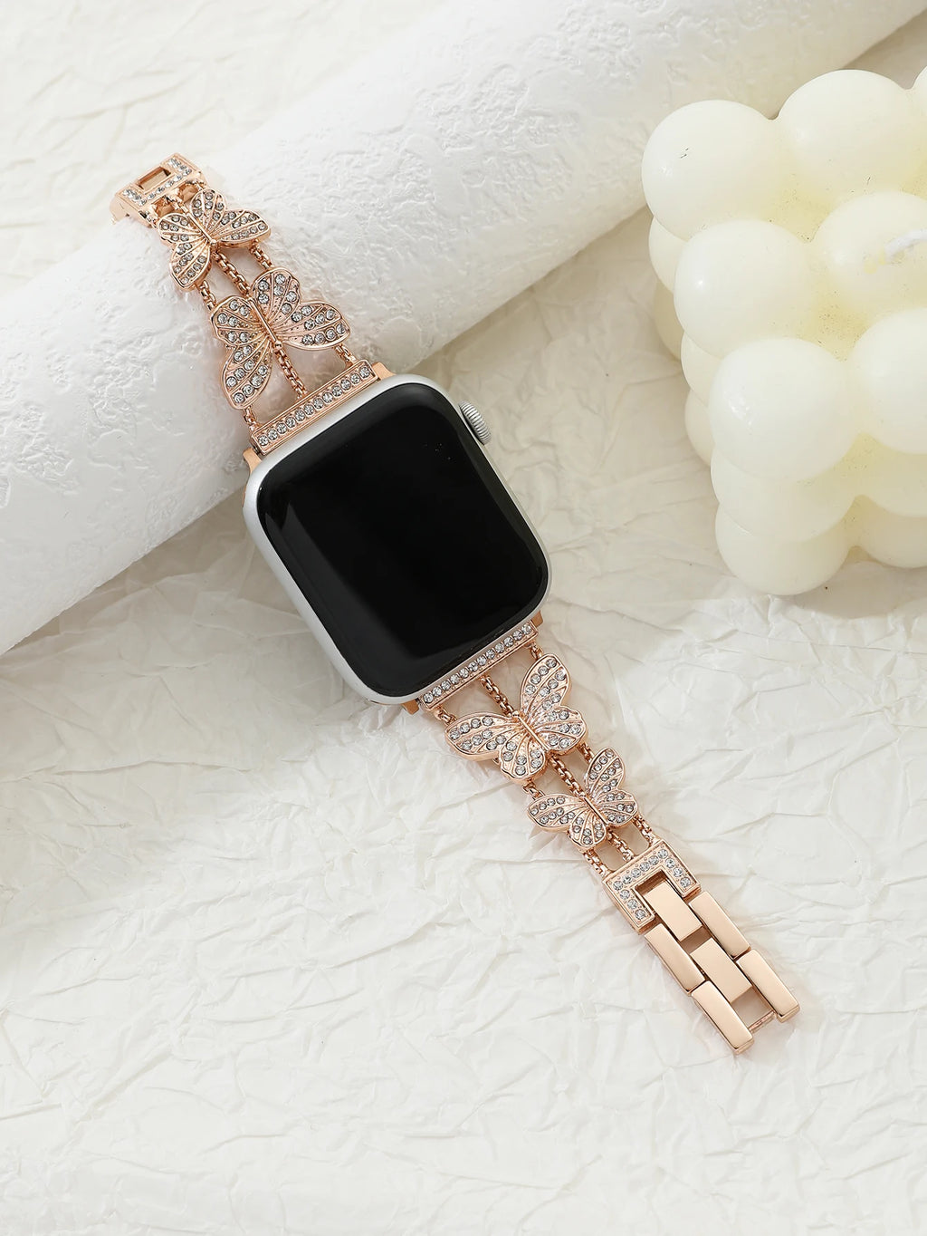 Shiny butterfly metal strap for Apple Watch with a stylish luxury look, fits multiple sizes and series.