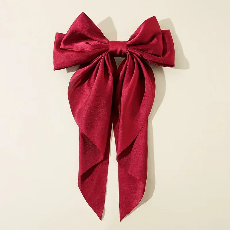 Elegant satin bow hair clip with strong hold and soft feminine style.